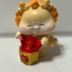 Adorable Figurine with Red and Gold Accents